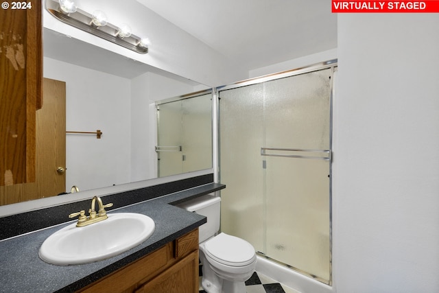 bathroom featuring vanity, toilet, and walk in shower