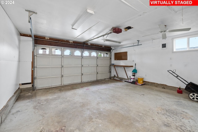 garage featuring a garage door opener and ceiling fan