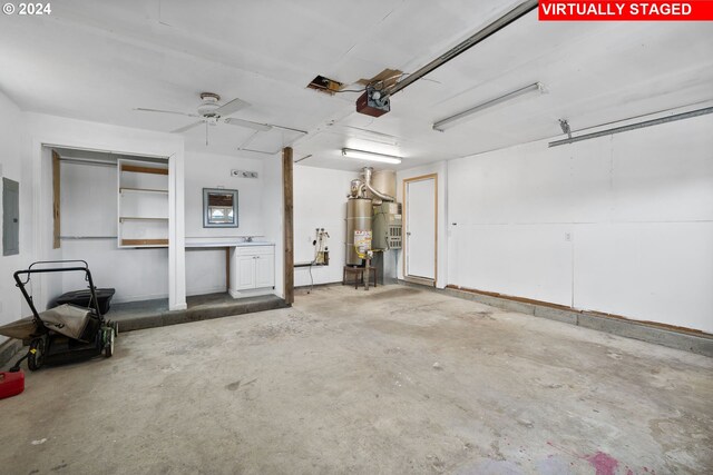 garage with electric panel, water heater, ceiling fan, and a garage door opener