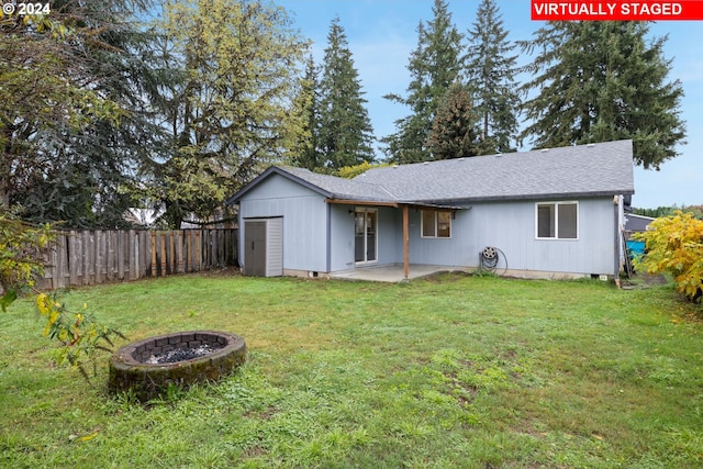 back of house with a patio area and a lawn