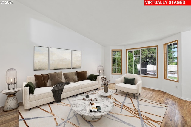 living room featuring hardwood / wood-style floors and vaulted ceiling