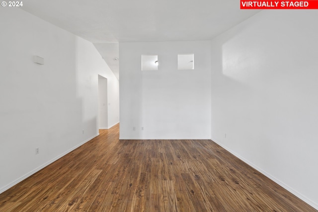 spare room with dark hardwood / wood-style flooring