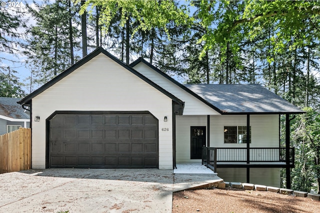 ranch-style home with a garage and covered porch