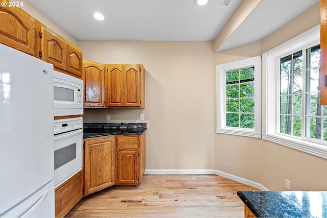 kitchen featuring light wood-type flooring and white appliances