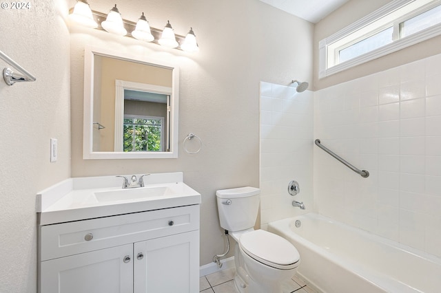 full bathroom featuring toilet, vanity, tile patterned floors, and tiled shower / bath combo