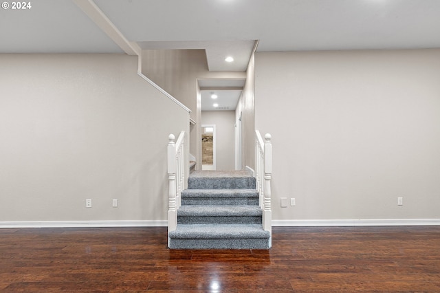 staircase featuring wood-type flooring