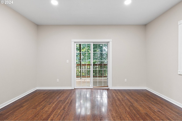 empty room featuring dark hardwood / wood-style flooring