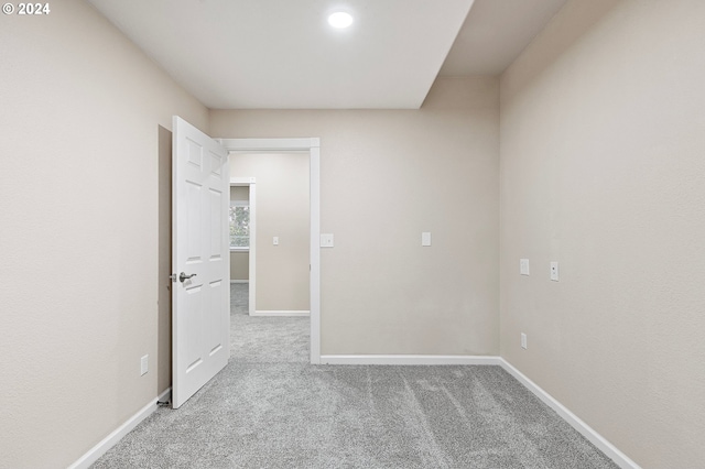 spare room with light colored carpet