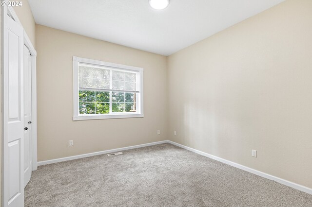 unfurnished bedroom featuring light colored carpet