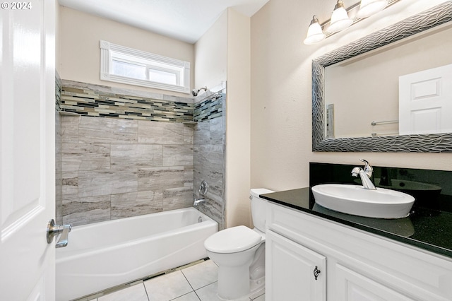 full bathroom featuring vanity, tile patterned flooring, tiled shower / bath, and toilet