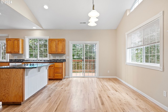 kitchen featuring pendant lighting, vaulted ceiling, and a wealth of natural light