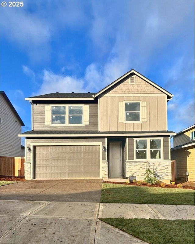 view of front of home with a front yard and a garage