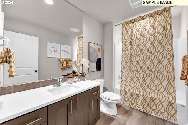 full bathroom with wood-type flooring, toilet, vanity, and shower / bath combination with curtain