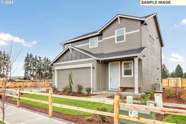 craftsman inspired home featuring a garage and a front yard