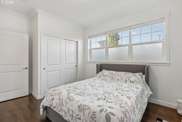 bedroom featuring a closet, dark wood-type flooring, and ornamental molding