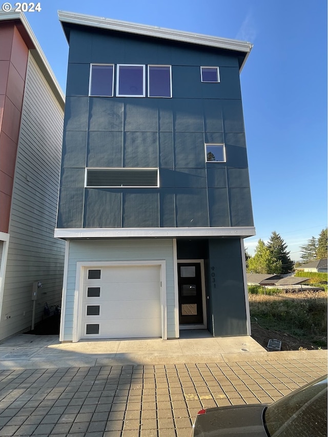 rear view of property featuring a garage