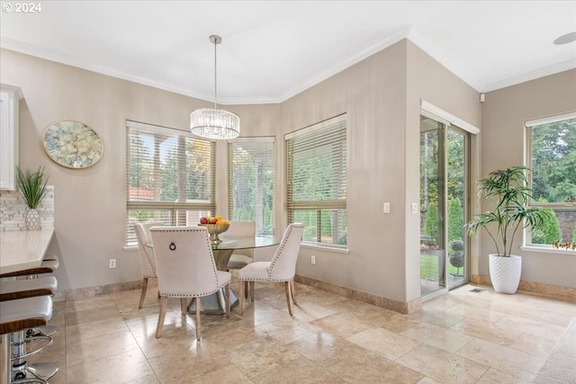 dining space with a notable chandelier and ornamental molding