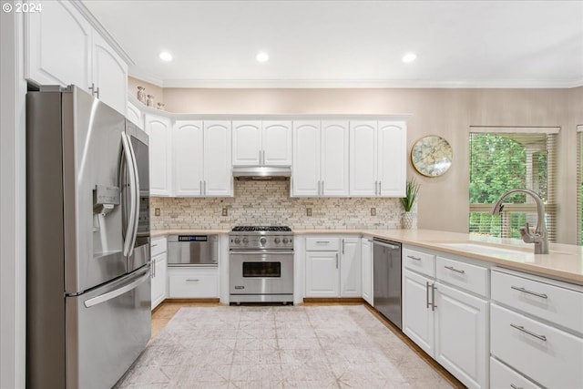 kitchen featuring appliances with stainless steel finishes, backsplash, ventilation hood, sink, and white cabinets