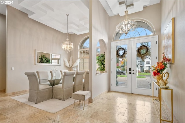 entryway featuring a high ceiling, a wealth of natural light, and french doors