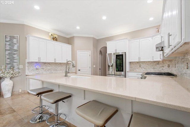 kitchen featuring kitchen peninsula, sink, white cabinets, and stainless steel appliances