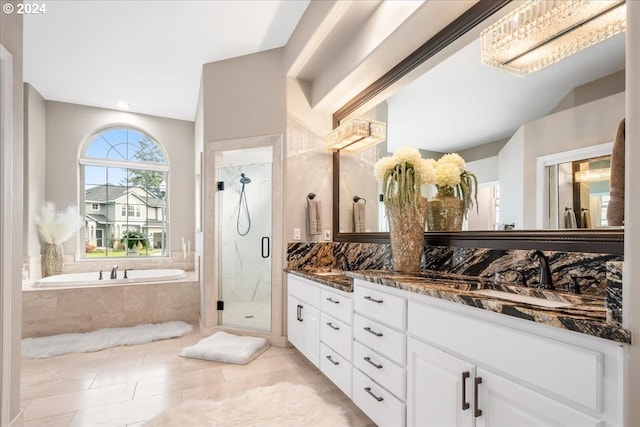 bathroom featuring tile patterned flooring, vanity, and plus walk in shower