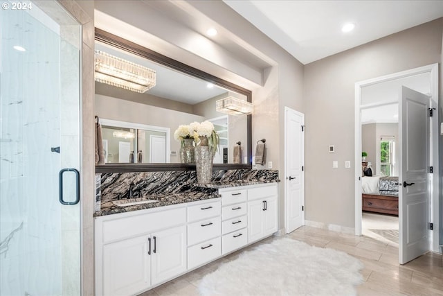 bathroom featuring vanity and a shower with shower door