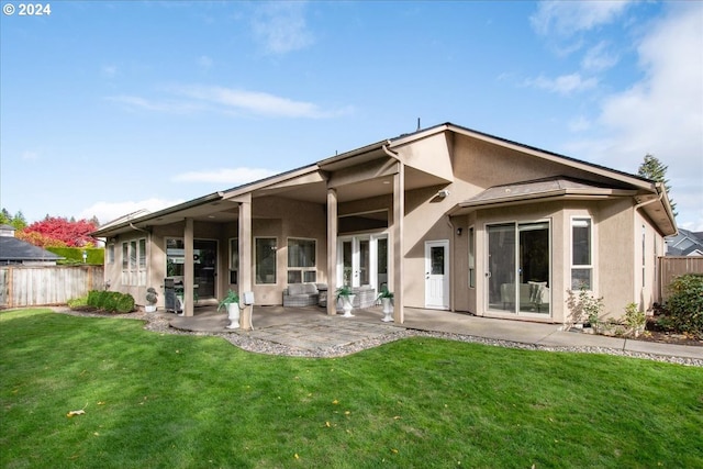 back of house featuring a patio area and a yard