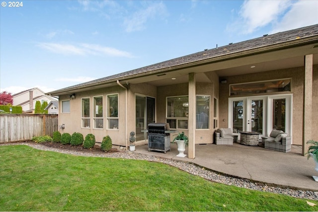 rear view of house featuring a lawn and a patio