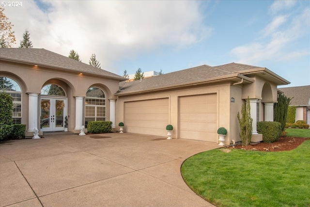 view of front of house with a garage, a front yard, and french doors