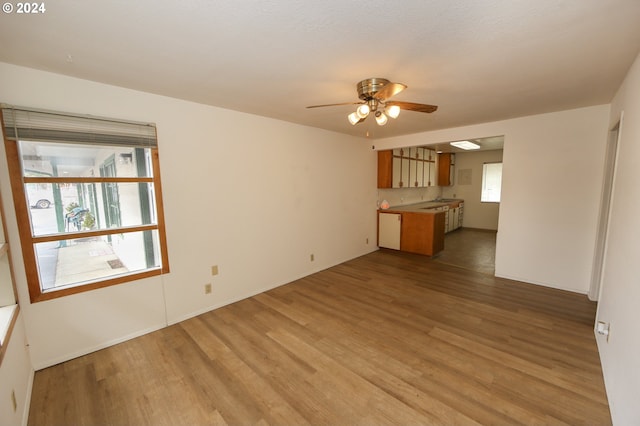 542 Pacific Ave, Brookings, OR 97415 - unfurnished living room featuring light wood finished floors, ceiling fan, and baseboards