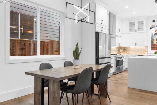 dining space with light hardwood / wood-style floors