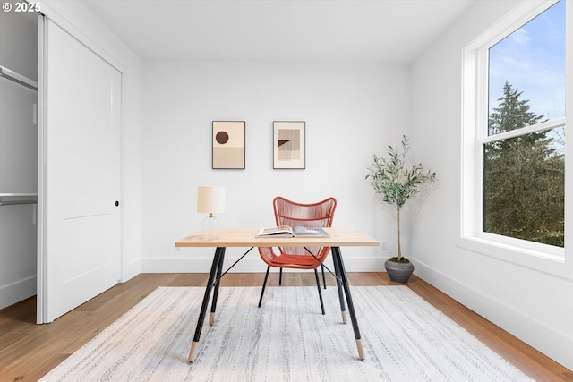 office with light wood-type flooring