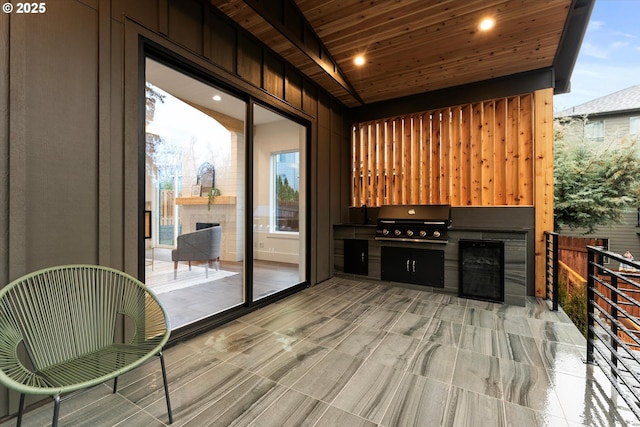 interior space with exterior fireplace and wooden ceiling