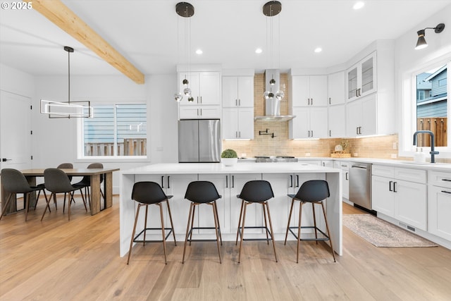 kitchen featuring sink, stainless steel appliances, white cabinets, and a kitchen island