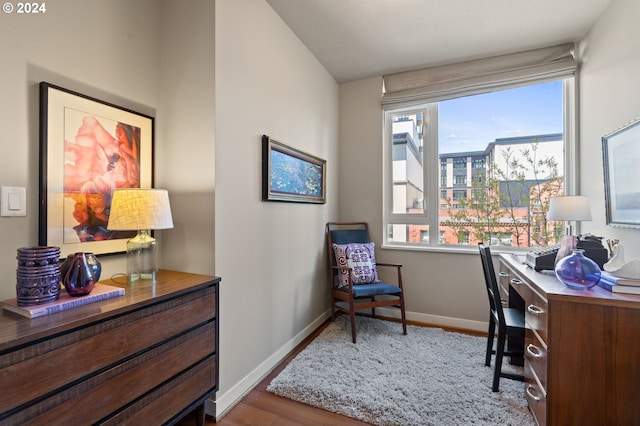 office space with light hardwood / wood-style floors and vaulted ceiling