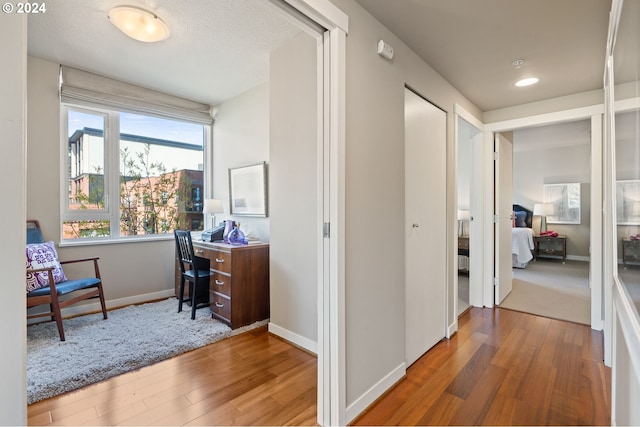 hallway with hardwood / wood-style floors