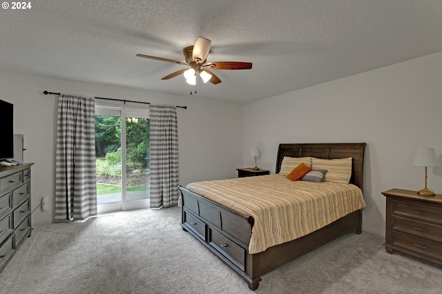 bedroom featuring light carpet, access to outside, a textured ceiling, and ceiling fan