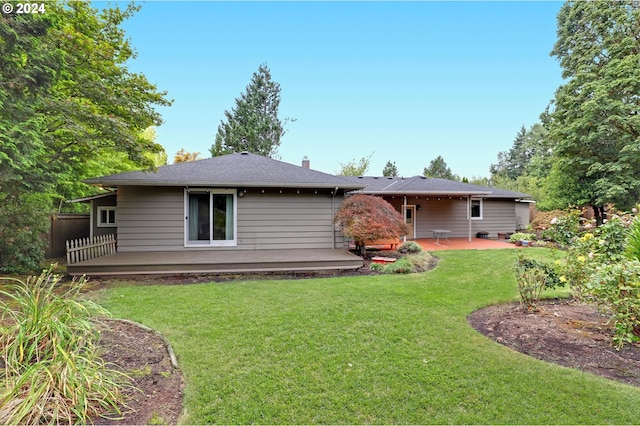 back of house featuring a patio and a yard