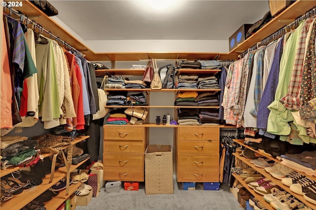 walk in closet featuring light colored carpet