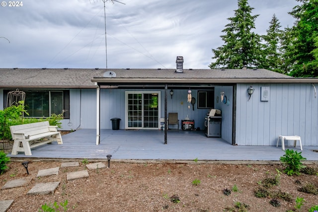 back of house with a wooden deck