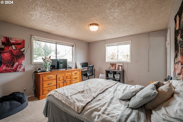 carpeted bedroom with multiple windows and a textured ceiling