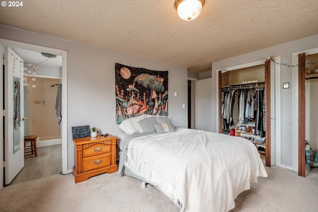 carpeted bedroom with a closet and a textured ceiling