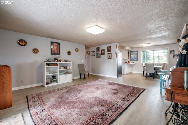 interior space featuring a textured ceiling and hardwood / wood-style floors