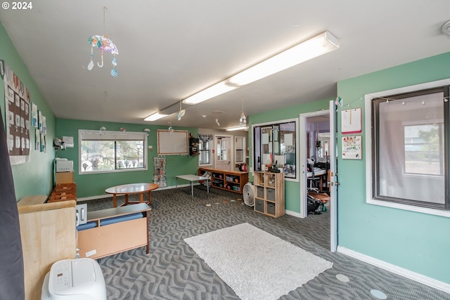 miscellaneous room with dark carpet