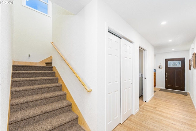 stairway featuring recessed lighting, baseboards, and wood finished floors