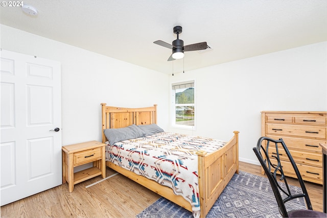 bedroom with ceiling fan and wood finished floors