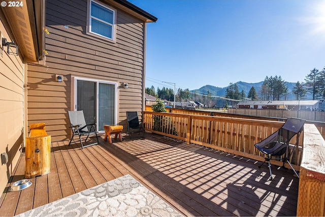 deck featuring fence and a mountain view