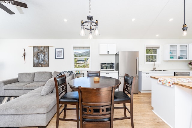 dining room featuring light wood finished floors, an inviting chandelier, and recessed lighting