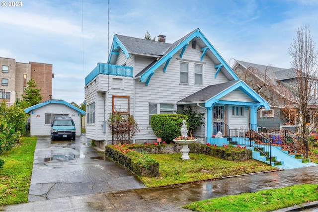 view of front of house featuring a garage and an outdoor structure