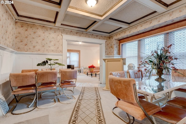 carpeted dining area with a wealth of natural light, beamed ceiling, and coffered ceiling